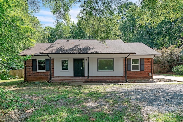 711 E John St, Matthews, NC 28105 - view of front facade with a porch, brick siding, and a shingled roof