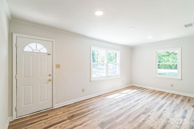 711 E John St, Matthews, NC 28105 - foyer with healthy amount of natural light, crown molding, light wood-type flooring, and recessed lighting