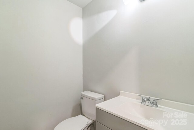 711 E John St, Matthews, NC 28105 - half bathroom featuring vanity and toilet