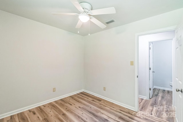 711 E John St, Matthews, NC 28105 - spare room with wood finished floors and a ceiling fan