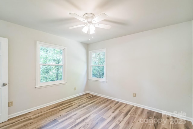 711 E John St, Matthews, NC 28105 - spare room with light wood finished floors and a ceiling fan