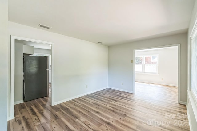 711 E John St, Matthews, NC 28105 - spare room featuring wood finished floors
