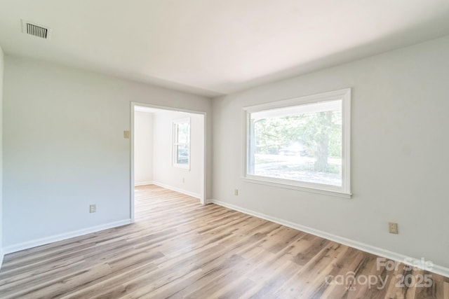 711 E John St, Matthews, NC 28105 - unfurnished room with light wood finished floors and baseboards