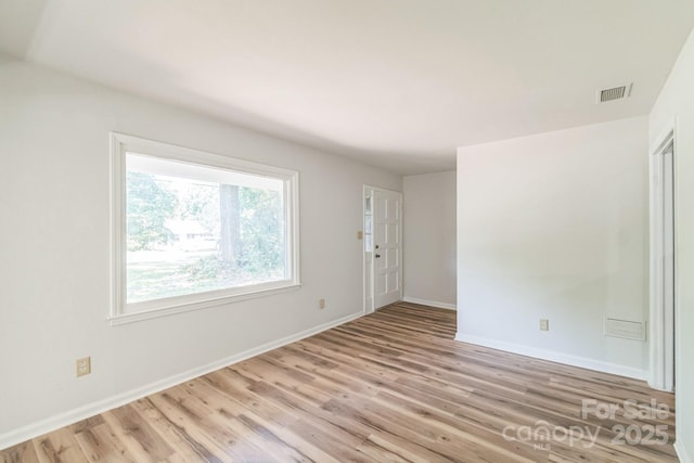 711 E John St, Matthews, NC 28105 - spare room featuring light wood-type flooring