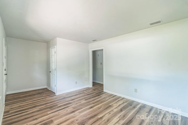 711 E John St, Matthews, NC 28105 - empty room with wood finished floors and baseboards