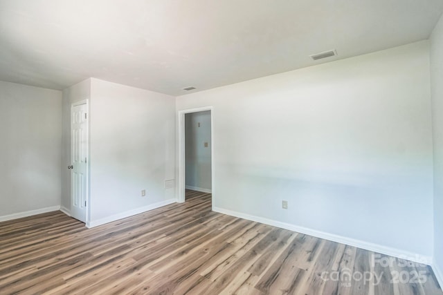 711 E John St, Matthews, NC 28105 - spare room with baseboards and wood finished floors