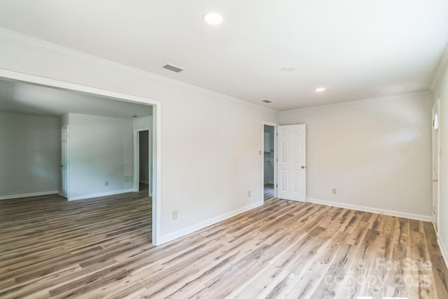 711 E John St, Matthews, NC 28105 - empty room featuring wood finished floors, recessed lighting, and ornamental molding