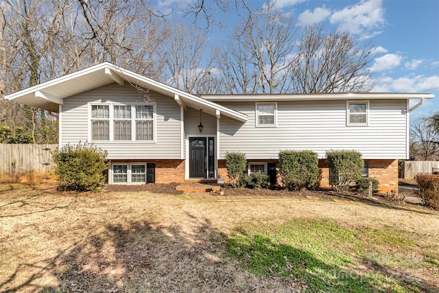 split foyer home featuring a front lawn