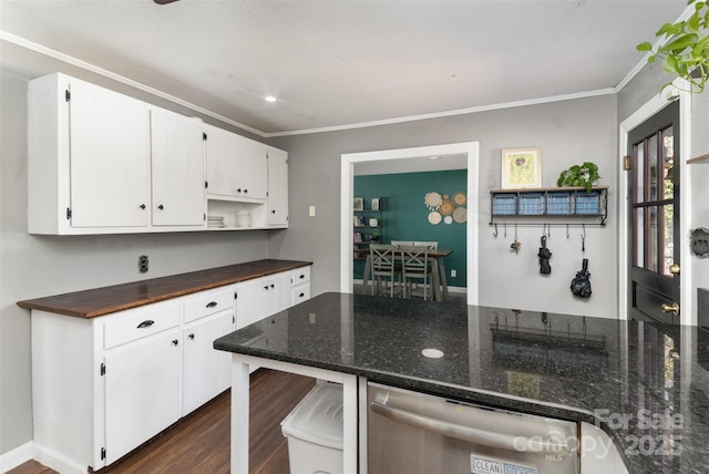 kitchen with white cabinetry, crown molding, dark hardwood / wood-style floors, and dark stone countertops