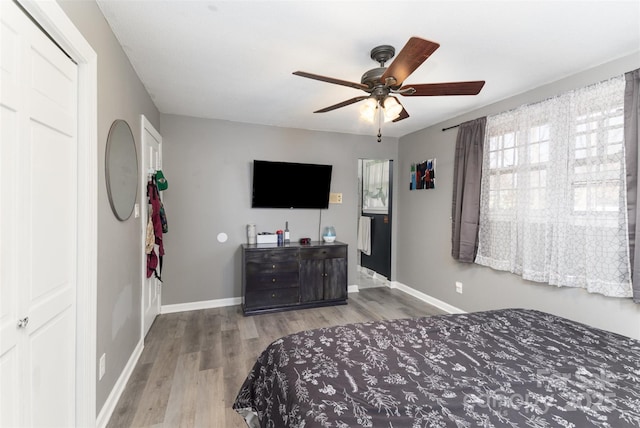 bedroom with ceiling fan and light wood-type flooring