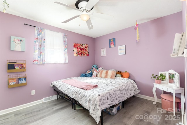 bedroom featuring hardwood / wood-style flooring and ceiling fan