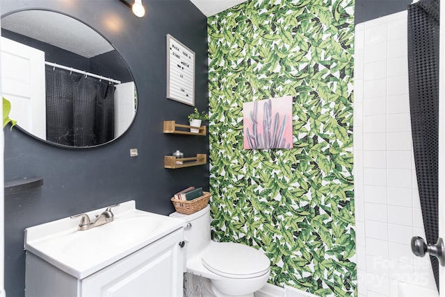 bathroom with vanity, toilet, and curtained shower