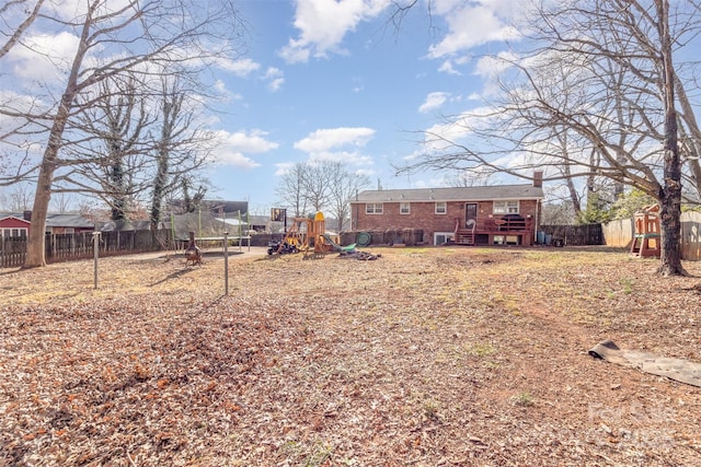 view of yard featuring a trampoline and a playground