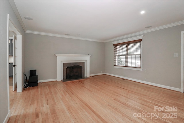 unfurnished living room with crown molding and light hardwood / wood-style floors