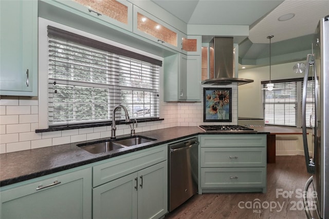 kitchen featuring pendant lighting, sink, stainless steel appliances, ventilation hood, and dark hardwood / wood-style flooring