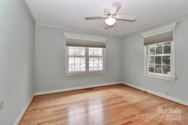 empty room featuring crown molding, light hardwood / wood-style floors, and ceiling fan