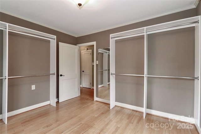 unfurnished bedroom featuring ornamental molding and light wood-type flooring