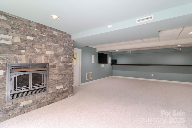 basement with carpet flooring and a fireplace