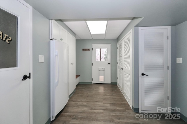 hall featuring dark hardwood / wood-style floors and a drop ceiling