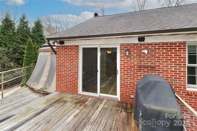 wooden terrace featuring a grill