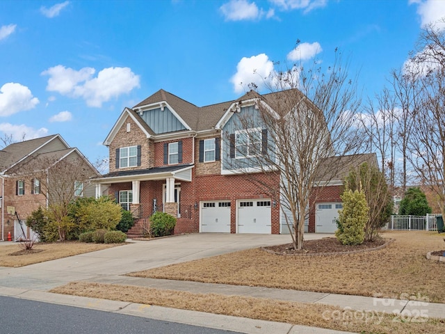 craftsman house with fence, board and batten siding, concrete driveway, a garage, and brick siding