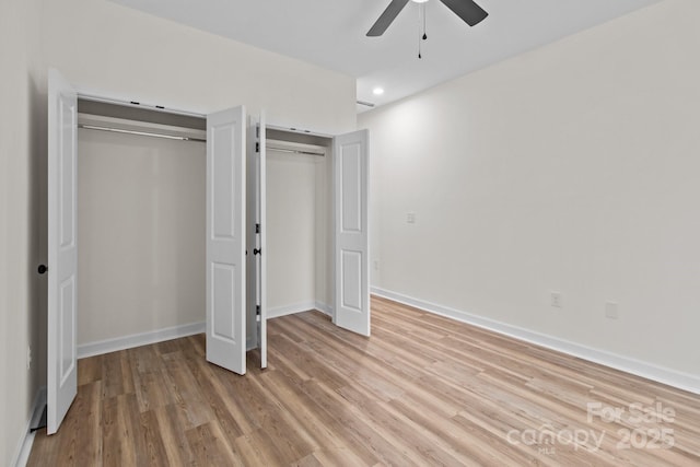 unfurnished bedroom with ceiling fan and light wood-type flooring