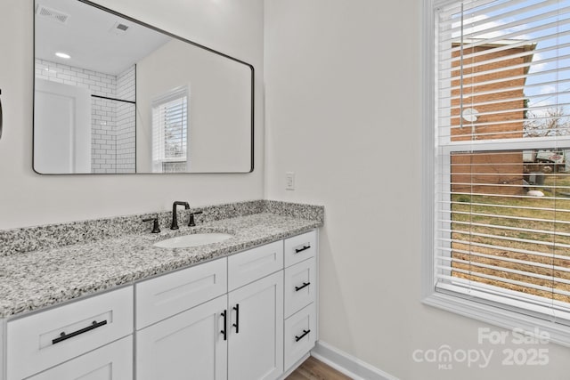 bathroom featuring vanity and a shower