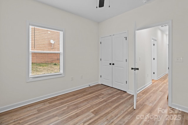 unfurnished bedroom with ceiling fan and light hardwood / wood-style floors