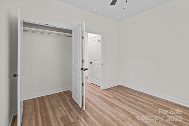 unfurnished bedroom featuring a closet, ceiling fan, and light wood-type flooring