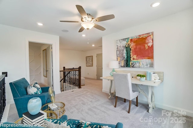 office space featuring light colored carpet and ceiling fan