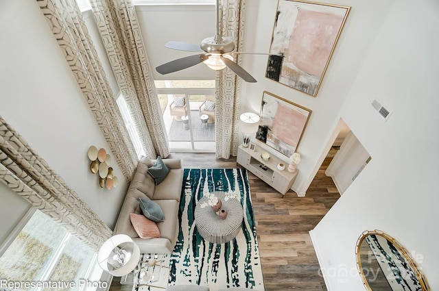 living room featuring wood-type flooring and ceiling fan