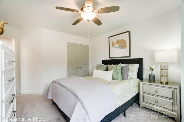 bedroom with light carpet, a closet, and ceiling fan