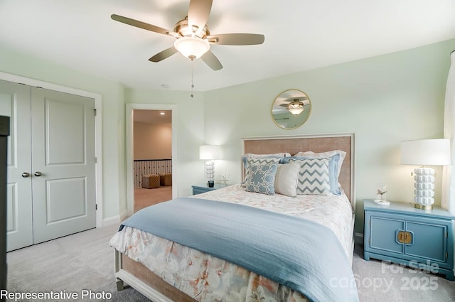carpeted bedroom with ceiling fan and a closet