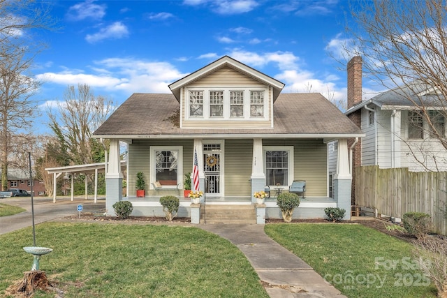 view of front of home with a porch and a front yard