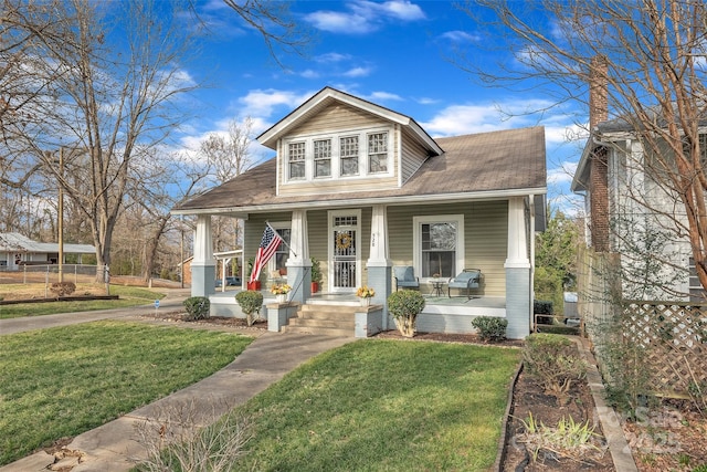 bungalow-style home featuring a porch and a front lawn