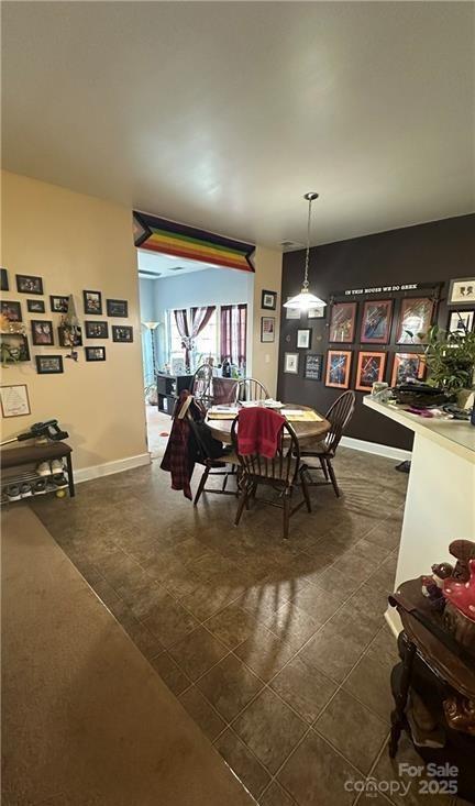 dining area with dark tile patterned flooring