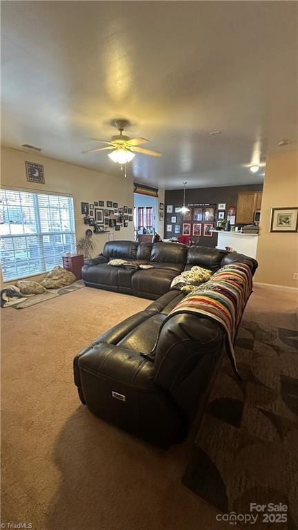 living room featuring carpet floors and ceiling fan