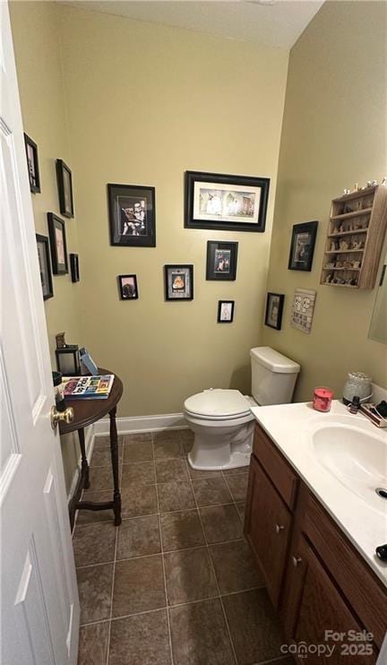 bathroom featuring tile patterned floors, vanity, and toilet