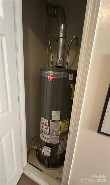 utility room featuring gas water heater