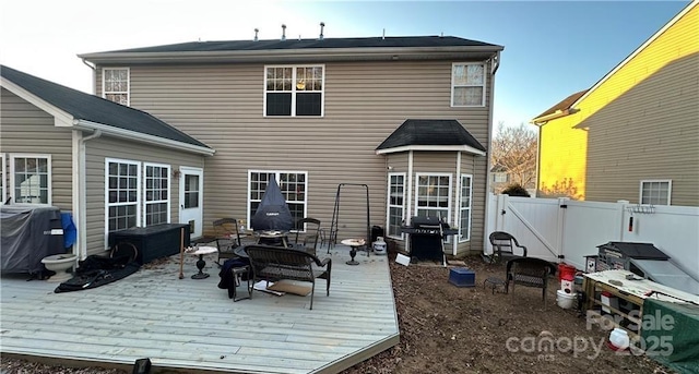 rear view of house featuring a deck