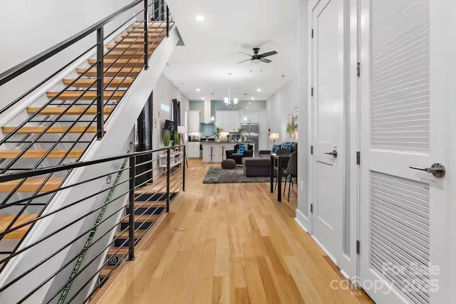 interior space featuring a notable chandelier and light wood-type flooring