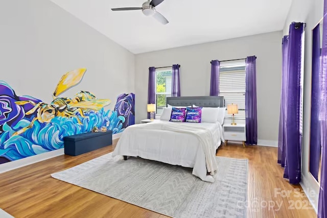 bedroom with hardwood / wood-style floors and ceiling fan