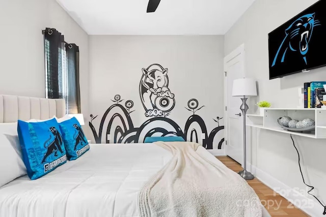 bedroom with hardwood / wood-style floors and ceiling fan