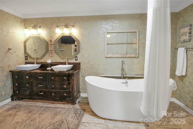 bathroom featuring wood-type flooring, crown molding, and a tub to relax in