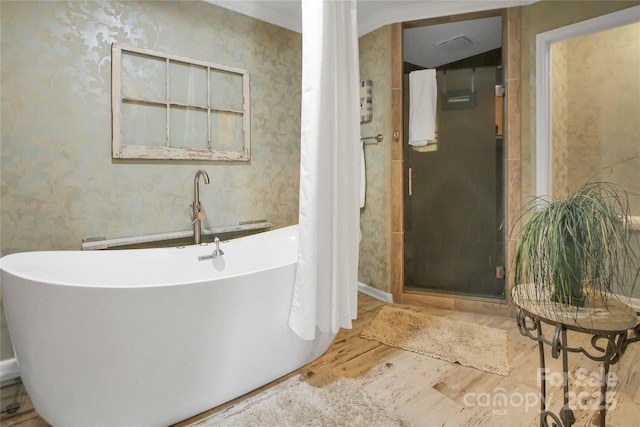 bathroom featuring wood-type flooring and plus walk in shower