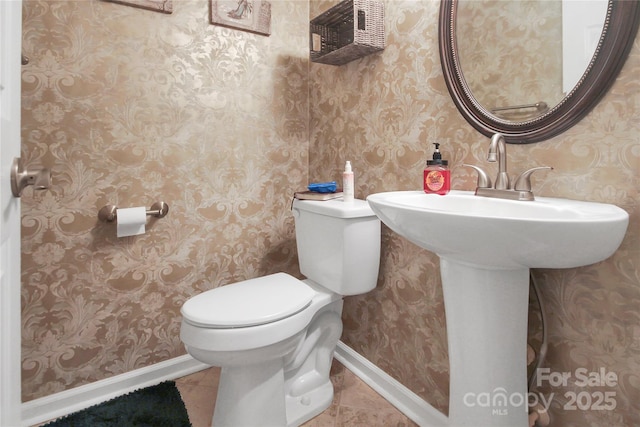 bathroom with tile patterned flooring and toilet