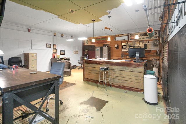 interior space featuring a wall mounted AC and concrete floors