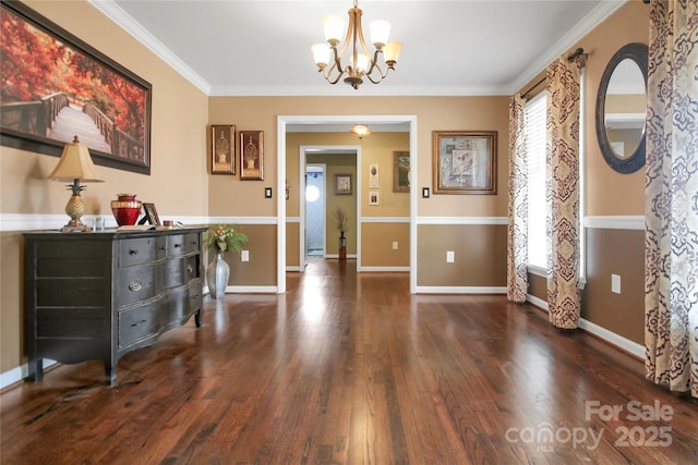 interior space with ornamental molding, a notable chandelier, and dark hardwood / wood-style flooring