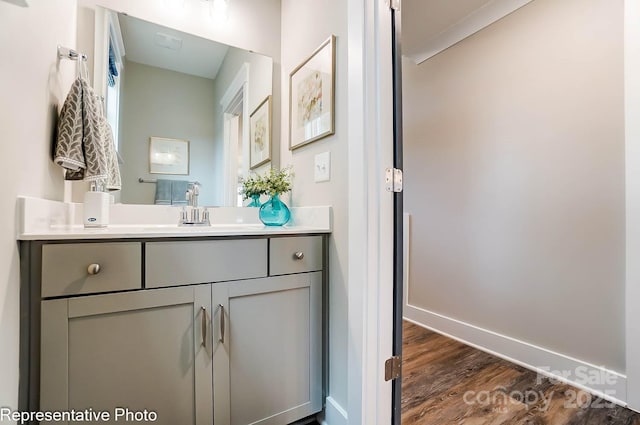 bathroom with vanity and hardwood / wood-style flooring