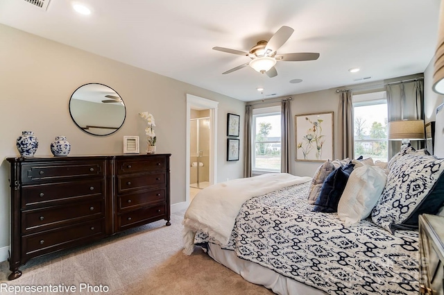 carpeted bedroom with ceiling fan and ensuite bathroom